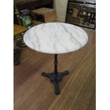 A cast iron and white marble pub table, the circular marble top over a turned stem and a rope-