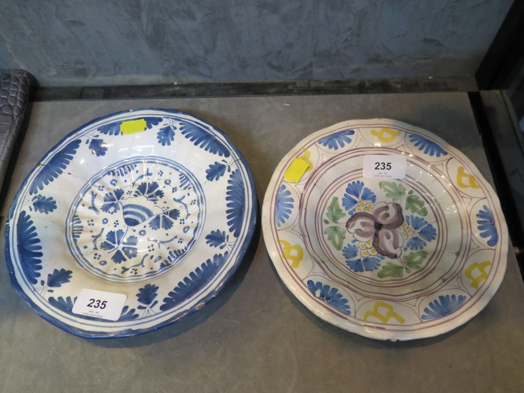 Two 18th century German faience plates, both with floral decoration, blue and white 22 cm