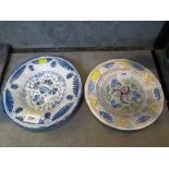 Two 18th century German faience plates, both with floral decoration, blue and white 22 cm