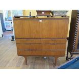 A teak secretaire by Meredew Furniture, the fall front over two short and two long drawers, on