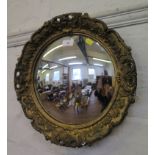 A giltwood circular convex wall mirror, with foliate design frame, 41.5 cm diameter