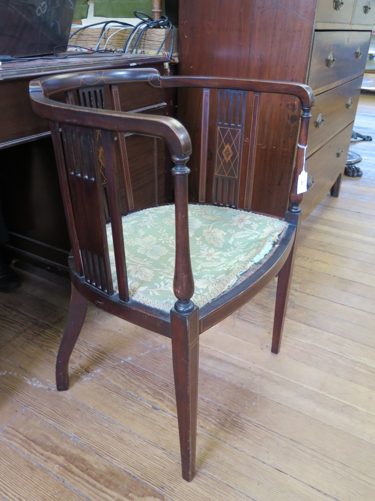 An Edwardian inlaid mahogany tub chair, with tablet and rail back, upholstered seat and tapering