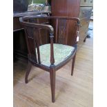 An Edwardian inlaid mahogany tub chair, with tablet and rail back, upholstered seat and tapering