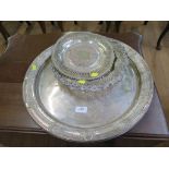 A large round silver plated tray and two others