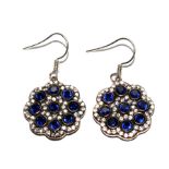 A pair of silver earrings set with faux diamonds and sapphires