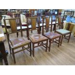 A set of four 1920s oak framed dining chairs, the top rails with exposed dovetails above leather