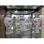 A pair of famille rose baluster vases and covers, with chrysanthemum and floral design, 34cm high (