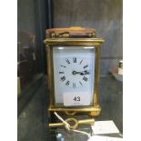 A brass carriage clock timepiece, of conventional form with enamel dial, fitted case and key, 15