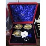 A case for four silver salts, containing three salts cellars (one damaged)