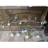 Four brass table lamps, lacking shades