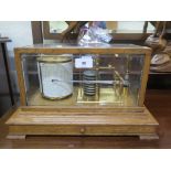 A Short & Mason barograph, with eight coils in an oak and bevelled glass case, with drawer below, 36