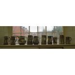 Ten brown jasperware jugs, including Ridgway and others, most with foliate or Classical designs, one