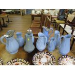 Ten Victorian stoneware relief moulded jugs, all in blue, including wheat ears by Dodson, 17 cm