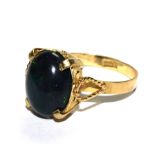 A continental gold ring set with cabochon black opal