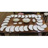 A set of twenty-six Victorian crescent shaped side plates, an oval serving dish and three tureens,