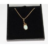 An opal pendant, set with 9 carat gold neck chain