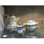 A three piece silver tea set to include tea pot (damaged) water jug and cream jug (sugar bowl
