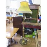 An Edwardian brass adustable standard lamp, with octagonal tapering stem and base with ball feet,