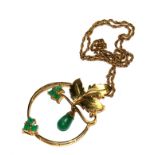 An emerald set gold colour metal pendant