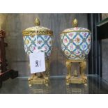 A pair of Sevres porcelain and gilt metal lidded pots, with floral and turquoise ribbon lattice