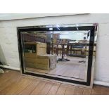 A modern rectangular bevelled mirror, with black glass border, 70 x 100 cm