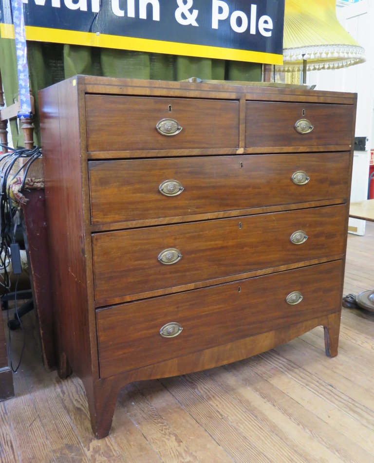 An early 19th century mahogany and line inlaid chest of drawers, with two short and three long