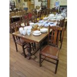 A 1920s draw leaf dining table, the rectangular top on cup and cover supports joined by a stretcher,