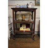 An Edwardian walnut three tier whatnot, with shaped rectangular shelves on cabriole legs and