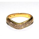 A diamond set wish bone ring in 18 carat yellow gold