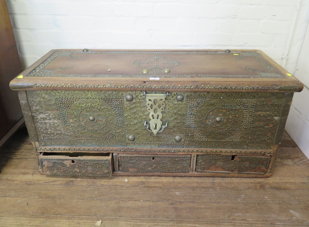 A Morrocan style camphorwood and brass bound chest, the hinged lid enclosing a candle box, over