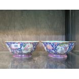 A pair of Chinese famille rose lotus shaped bowls, each with floral scroll blue ground and figural