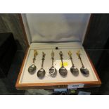 An unusual cased set of six coffee/tea spoons, silver plated with gilt terminals of various animals,