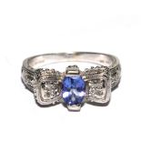 A diamond and tanzanite white gold ring set in 14 carat gold