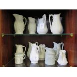 Thirteen Victorian and later stoneware relief moulded jugs, of various designs, including Ridgway