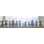 Various Victorian stoneware high relief jugs, in green, blue and cream, including an E. Ridgway &