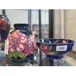 A Moorcroft Pottery pink orchid design tapering vase, dated 1996, 15 cm high, an earlier Moorcroft