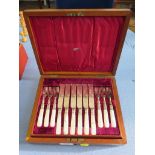 A cased set of six silver plated fruit knives with mother of pearl handle
