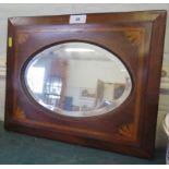An Edwardian satinwood crossbanded and patera inlaid wall mirror, with bevelled oval plate, 37 x