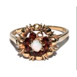 A 9 carat gold ring set with pearl and garnet