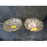 Two small pierced silver dishes, each on three feet, Walker and Hall, Sheffield, 1926, 9cm diameter,