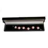 A silver bracelet with six red and white enamel roundels, boxed