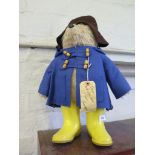 A Gabrielle Designs Paddington Bear, with brown hat, blue coat and yellow wellies, 53 cm high