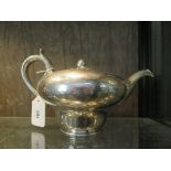 A William IV silver inverted baluster teapot, with worn engraved decoration, London May/June 1837,
