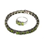 A silver bangle set with baguette peridot stone and a matching ring