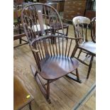 An Ercol stained beech and elm Windsor type rocking chair, with blue and gold label