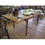 A 1970s teak extending dining table, with rectangular top, 198 cm x 81 cm