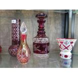 A Victorian cranberry and white overlay glass vase, of thistle shape with rose decoration, 12 cm