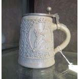 A German relief moulded stein, with pewter lid, 15 cm high