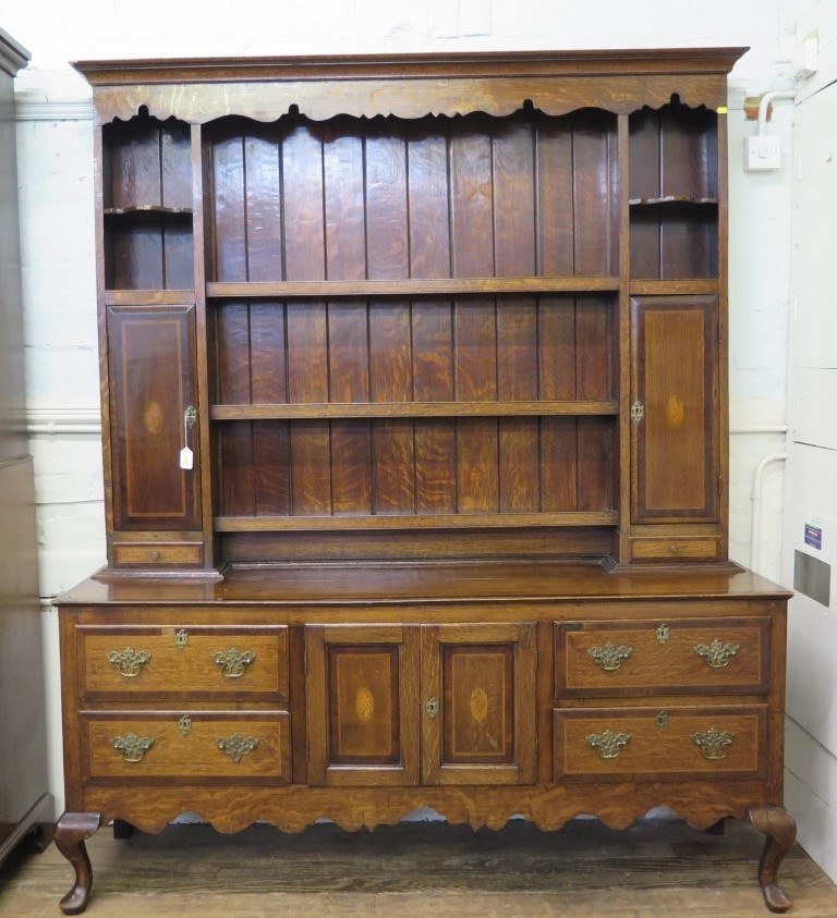 A George III cross and chevron banded oak dresser and rack, the rack with shelves flanked by