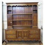 A George III cross and chevron banded oak dresser and rack, the rack with shelves flanked by